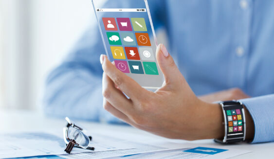 business, technology and people concept - close up of woman hand with application icons on transparent smartphone and smart watch screen